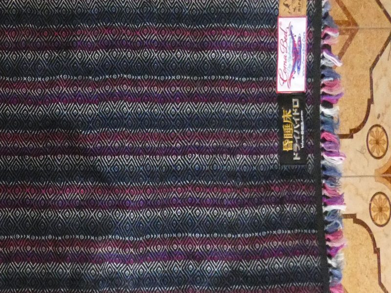 Coma Bed fabric detail — traditional textile surface